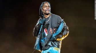 Travis Scott performing on stage during an event.