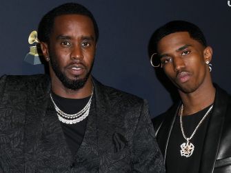 Father and son, Sean "Diddy" Combs and Christian "King" Combs, pose together at an event.