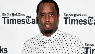 Sean "Diddy" Combs attending a public event, wearing a black and white polka dot shirt.
