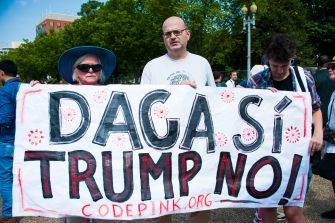 Protesters holding a banner that reads "DACA SÍ, TRUMP NO" during a demonstration advocating for the DACA program.