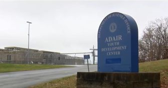 Signage for Adair Youth Development Center in Kentucky, amidst a backdrop of the facility's entrance.