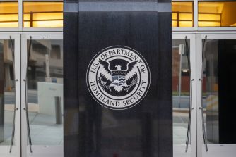 Seal of the U.S. Department of Homeland Security on a building entrance.