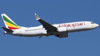 Ethiopian Airlines Boeing 737 MAX in flight against a clear blue sky.