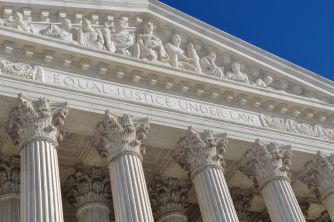 Image of the U.S. Supreme Court building, featuring the inscription "Equal Justice Under Law" above its columns.