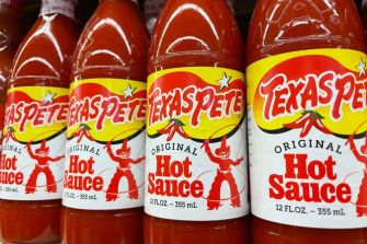 Bottles of Texas Pete hot sauce displayed on a store shelf.
