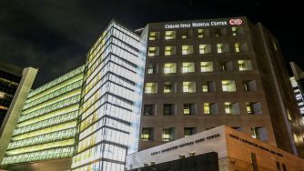 Image of Cedars-Sinai Medical Center's building at night.
