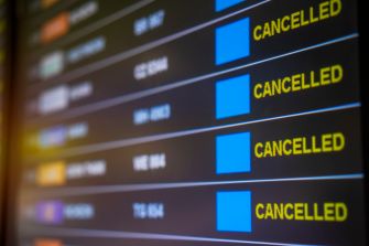 Flight departure board displaying multiple "CANCELLED" notices.