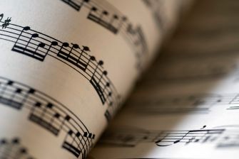 Close-up view of sheet music with musical notes on staff lines.
