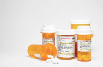 Several prescription pill bottles on a white surface.