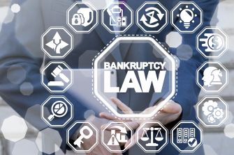 A person holding a tablet with a background featuring icons related to bankruptcy law and financial management.