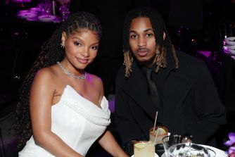 Halle Bailey and DDG posing together at a formal event.