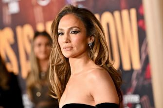 Image of a celebrity at a public event, posing for the camera with a serious expression.