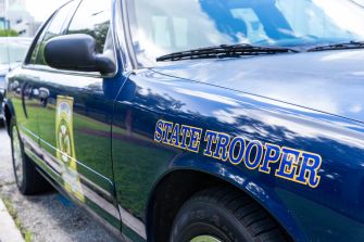 A close-up of a Pennsylvania state trooper vehicle featuring the words "STATE TROOPER" on the side.