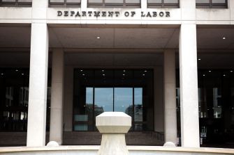 Building exterior with the words "Department of Labor" displayed prominently above the entrance.