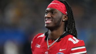 Marvin Harrison Jr. smiling while wearing a red football uniform and headband.
