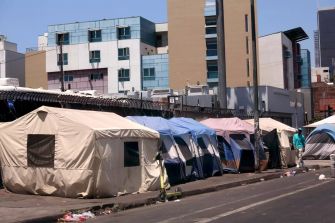 Tents set up along a city street, highlighting the issue of homelessness in California.