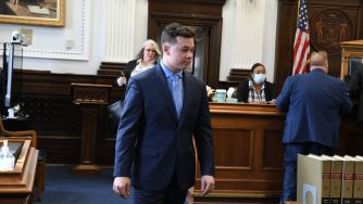 Kyle Rittenhouse entering a courtroom during his trial related to the fatal shooting incident in Kenosha, Wisconsin.