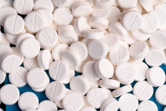 Pills laid out on a surface, some of which are identified as fentanyl.