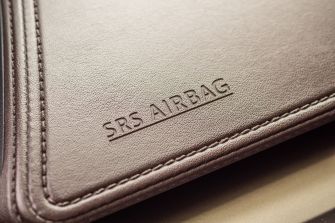Close-up of an SRS airbag label on a vehicle's interior.