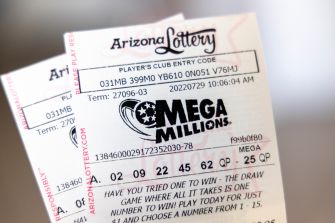 Close-up of an Arizona Lottery Mega Millions ticket with printed numbers.