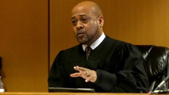 Judge in courtroom delivering a lecture after a controversial incident involving a teen during a field trip.