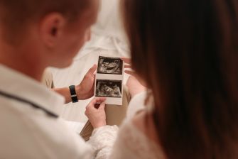 A couple holding an ultrasound image, symbolizing their journey through surrogacy.