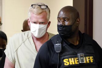 Alex Murdaugh being escorted by law enforcement following his arrest related to fraud charges and a failed suicide attempt.
