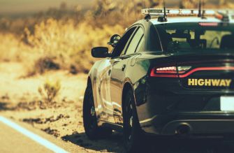 Police car on a highway with "HIGHWAY" written on the side.