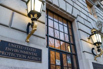 Exterior view of the United States Environmental Protection Agency building with visible lighting and signage.