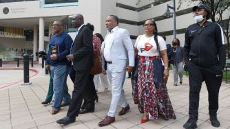 A group of individuals, including family members of Henrietta Lacks, walking outside a courthouse, highlighting the ongoing legal battle over Lacks' cells.