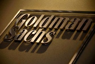 Goldman Sachs logo displayed on a wall.