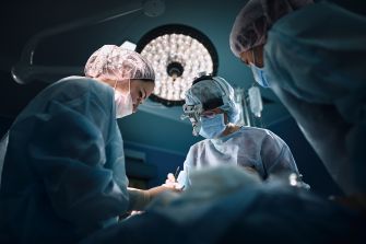 Surgical team in an operating room performing a procedure.