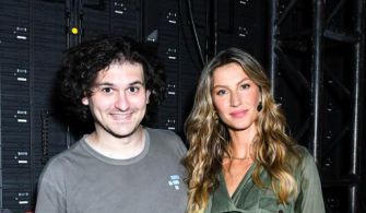 Image of Sam Bankman-Fried and Gisele Bündchen posing together at an event, with a background of equipment.