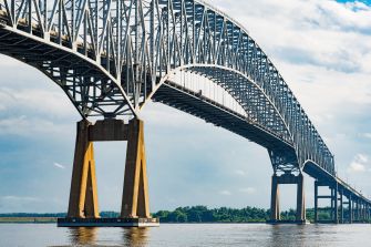 Blue steel Francis Scott Key Bridge truss spanning the water.