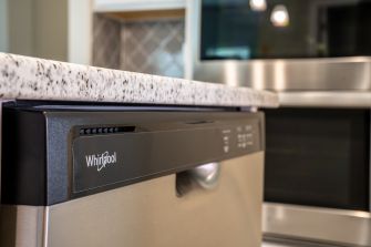 Close-up of a Whirlpool dishwasher in a modern kitchen.