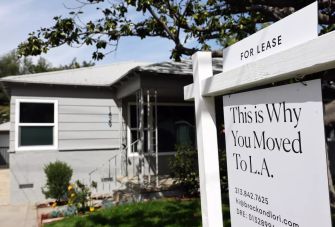 A rental home in California with a "For Lease" sign displaying a message about moving to Los Angeles.