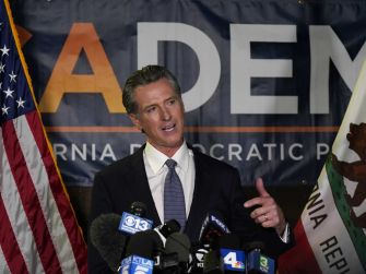 California Governor Gavin Newsom speaking at a press event, advocating for new gun legislation inspired by a Texas abortion law.