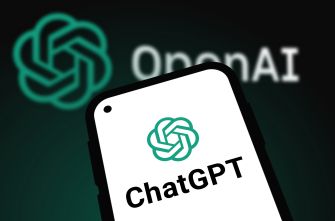 Smartphone displaying the ChatGPT icon with the OpenAI logo in the background