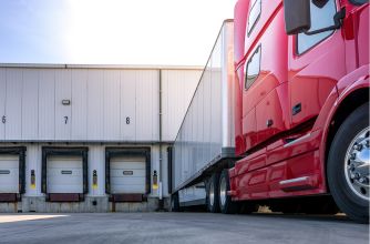Loading dock of a food processing facility with a red truck parked alongside.
