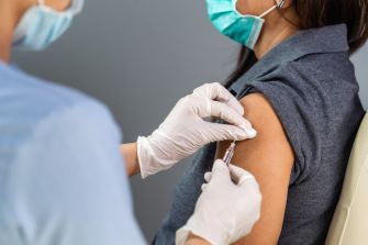 A healthcare professional administering a vaccine to a patient.