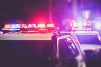 Police vehicles with flashing lights responding to an incident.