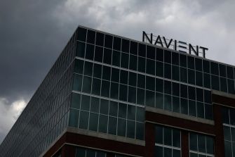 Building with "NAVIENT" sign against a stormy sky.