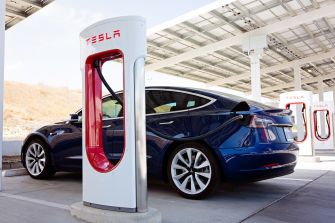 A Tesla vehicle charging at a Supercharger station.