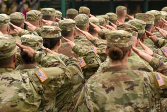 A group of military personnel in uniform saluting, highlighting the importance of honor and recognition in the armed forces.