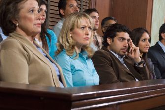 A diverse jury seated in a courtroom during a trial.