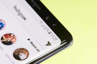 Close-up of a smartphone screen showing the Instagram app on a bright yellow background.
