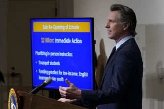 California Governor Gavin Newsom speaking at a press conference about state funding initiatives.