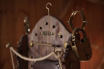 An old torture device with locks and ropes, symbolizing themes of violence and human rights violations.