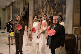 Protesters in wedding gowns and chains gather at the Massachusetts State House to advocate against child marriage laws.