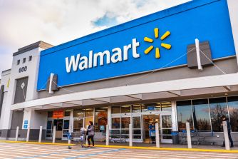 Walmart store exterior with customers entering and exiting.